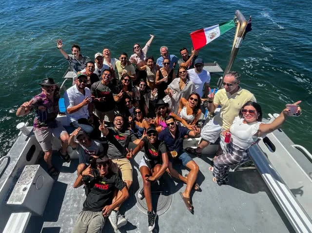 The NopalMates community aboard the boat on the Swan River, Mexican flag held high